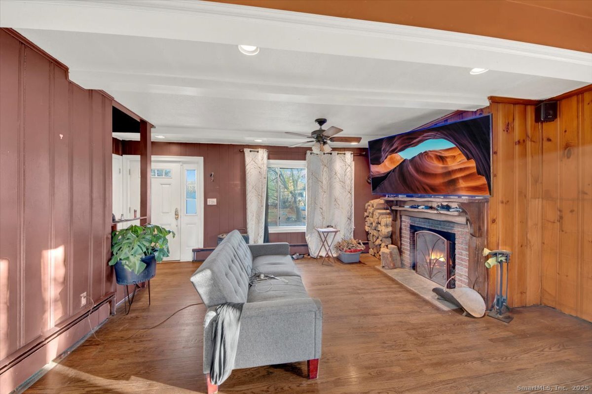 375 Silver Street Bridgeport, CT 06610 - Photo 13 of 21 a living room with furniture a fireplace and a floor to ceiling window