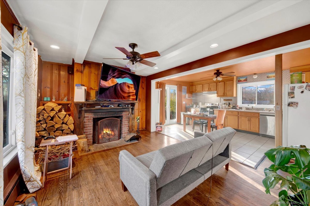 375 Silver Street Bridgeport, CT 06610 - Photo 14 of 21 a living room with furniture a fireplace and wooden floor