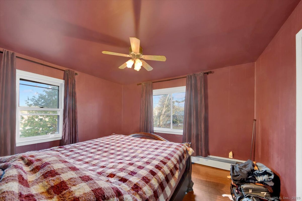 375 Silver Street Bridgeport, CT 06610 - Photo 15 of 21 a bedroom with a bed and a chandelier