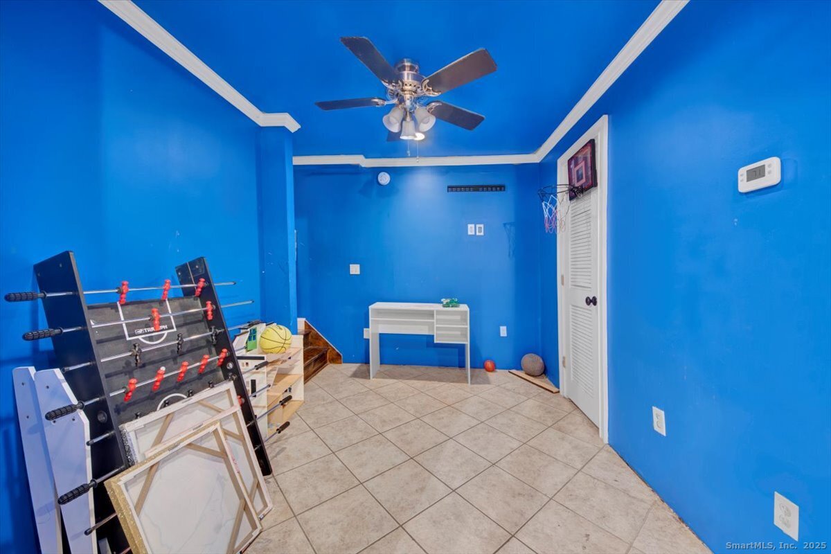 375 Silver Street Bridgeport, CT 06610 - Photo 17 of 21 a bedroom with a bed and a chandelier