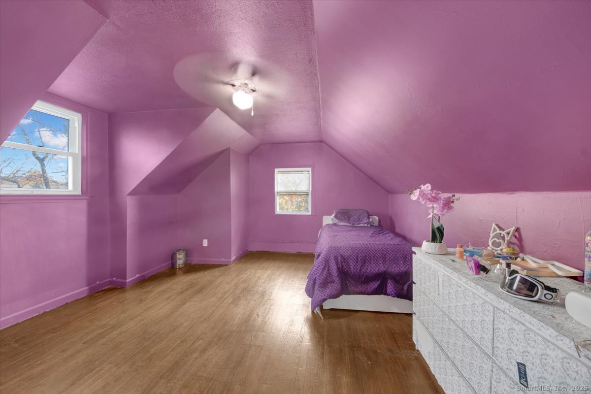 375 Silver Street Bridgeport, CT 06610 - Photo 18 of 21 a spacious bedroom with a bed and a chandelier