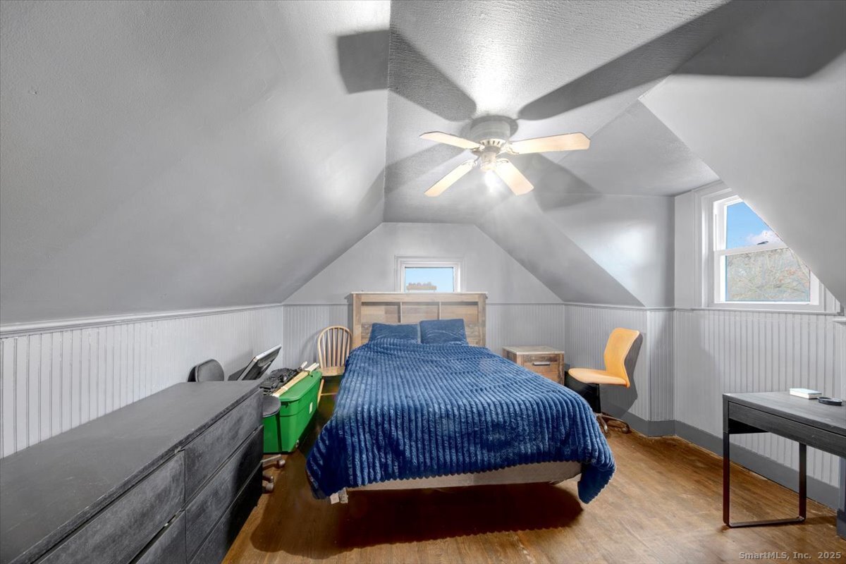 375 Silver Street Bridgeport, CT 06610 - Photo 19 of 21 a spacious bedroom with a bed and a chandelier