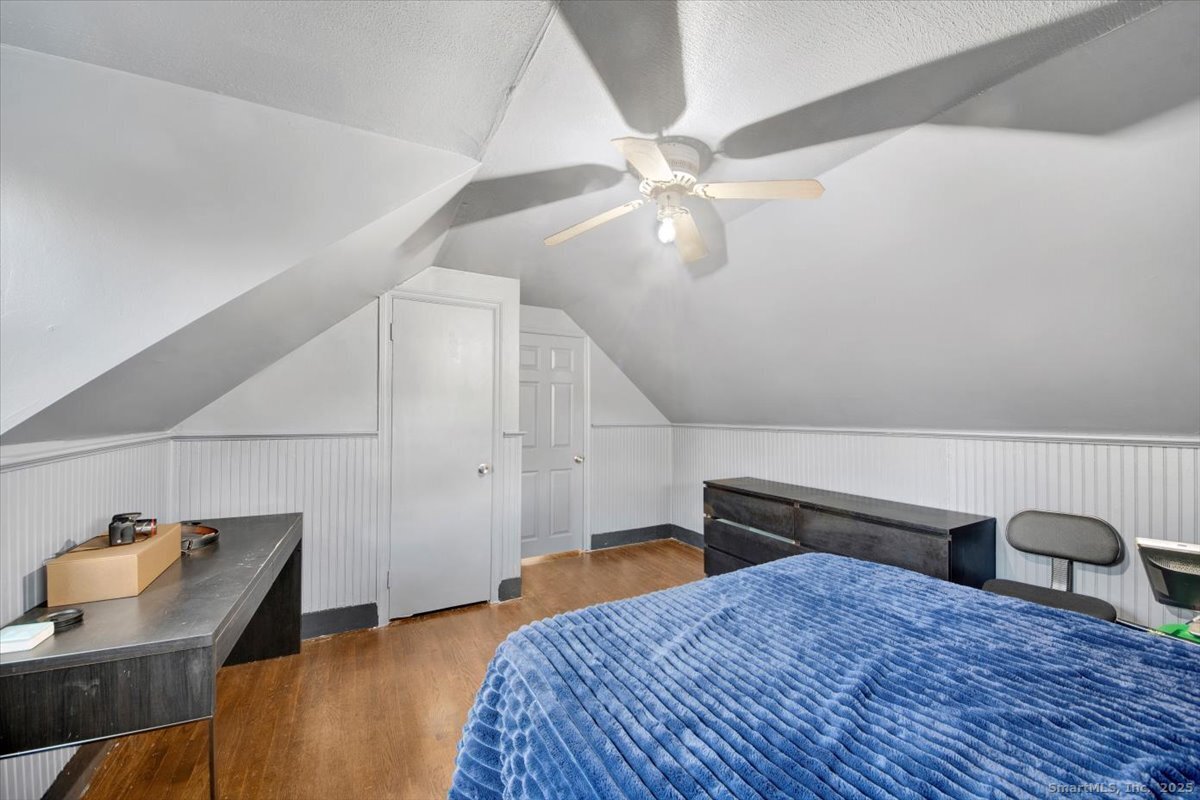 375 Silver Street Bridgeport, CT 06610 - Photo 20 of 21 a bedroom with a bed and a chandelier