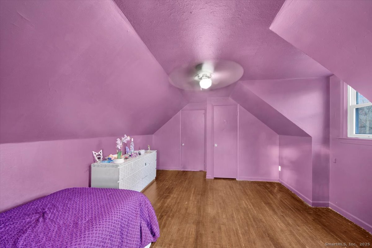 375 Silver Street Bridgeport, CT 06610 - Photo 21 of 21 a bed room with a bed mirror and a chandelier