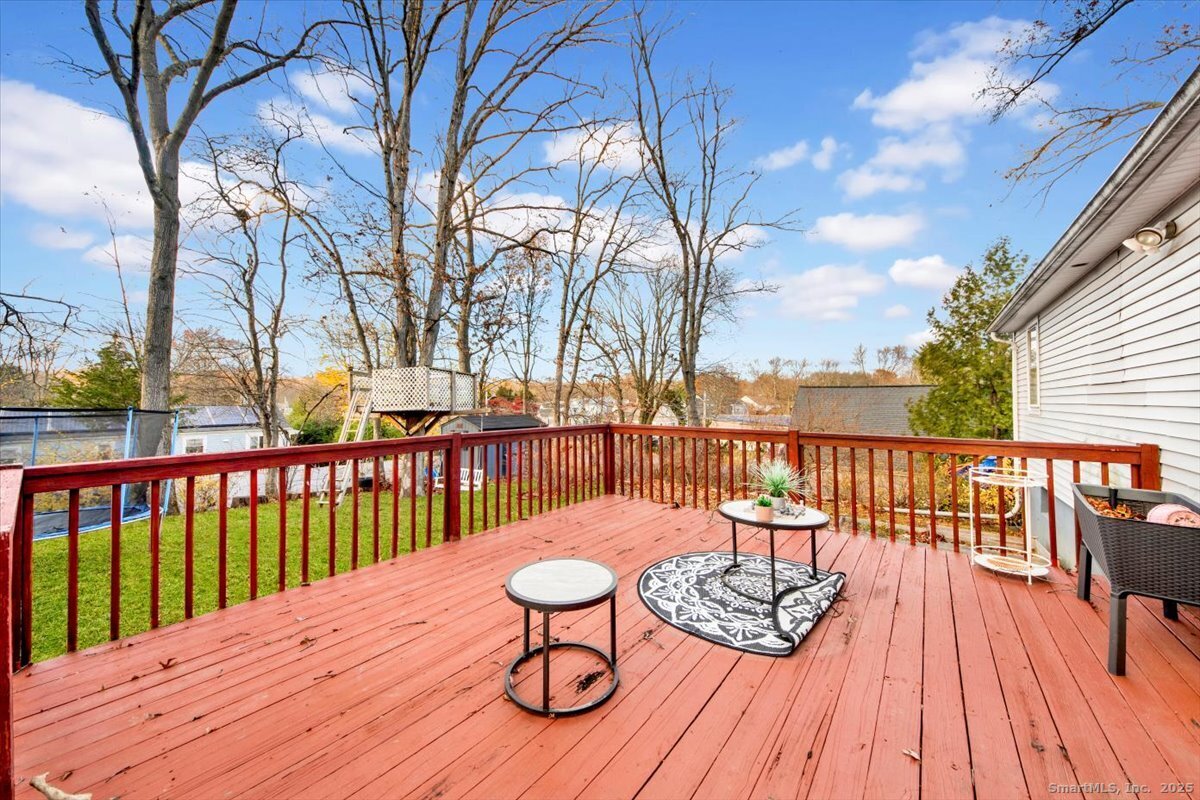 375 Silver Street Bridgeport, CT 06610 - Photo 9 of 21 a balcony with wooden floor table and chairs