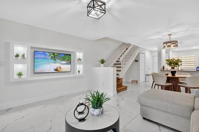 a living room with furniture and a chandelier