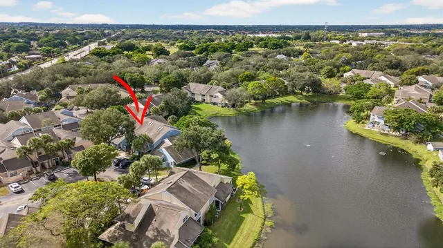 an aerial view of a house with a lake view