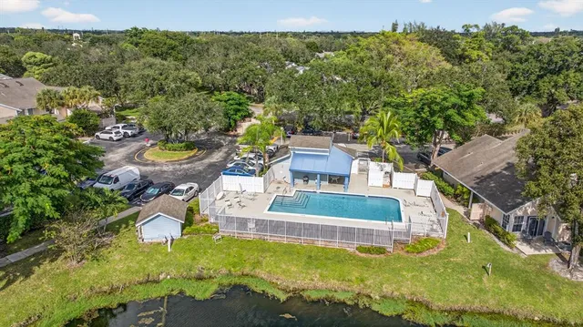 an aerial view of a house with swimming pool garden and mountain view