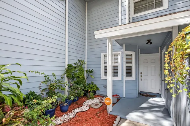 a view of a house with potted plants