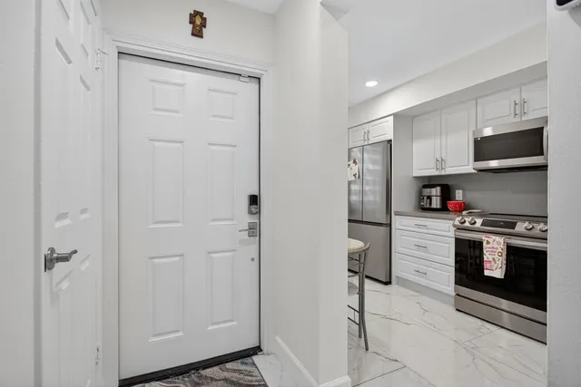 a kitchen with stainless steel appliances a refrigerator stove and microwave