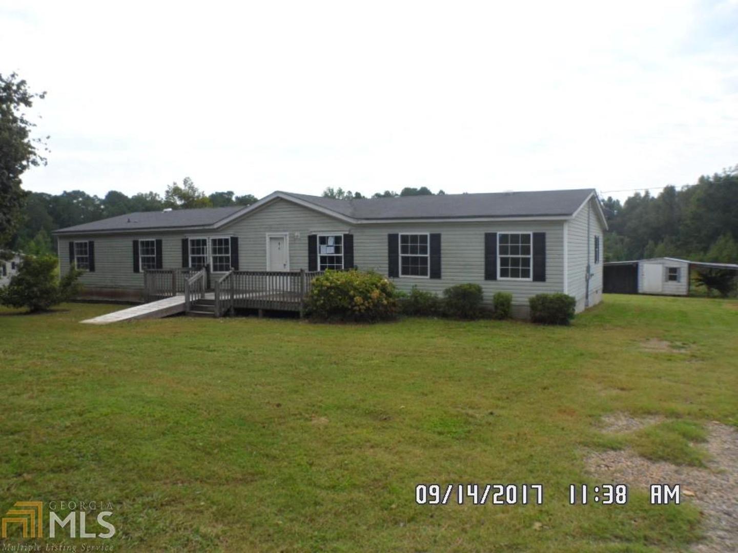 2915 Tommy Dillard Road Monroe, GA 30656 - Photo 1 of 1 a front view of a house with a garden