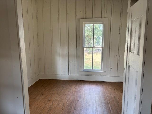 811 West 8th Street Cisco, TX 76437 - Photo 12 of 22 an empty room with wooden floor and windows
