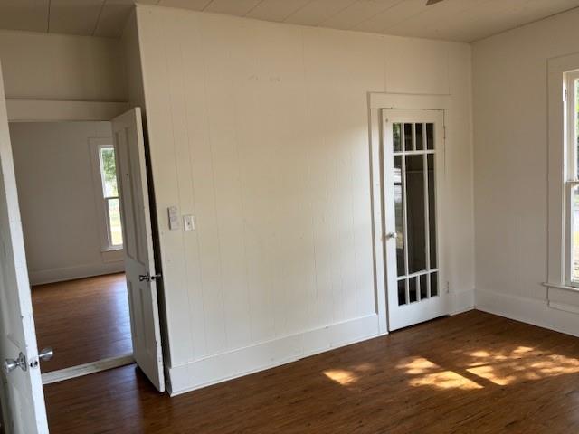 811 West 8th Street Cisco, TX 76437 - Photo 15 of 22 an empty room with wooden floor door and windows