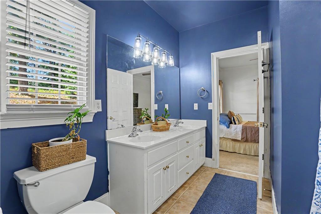 537 Old Collins Road Hoschton, GA 30548 - Photo 24 of 42 a en suite bathroom with a double vanity sink and a mirror