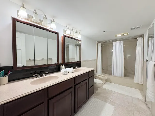 a bathroom with a double vanity sink and mirror