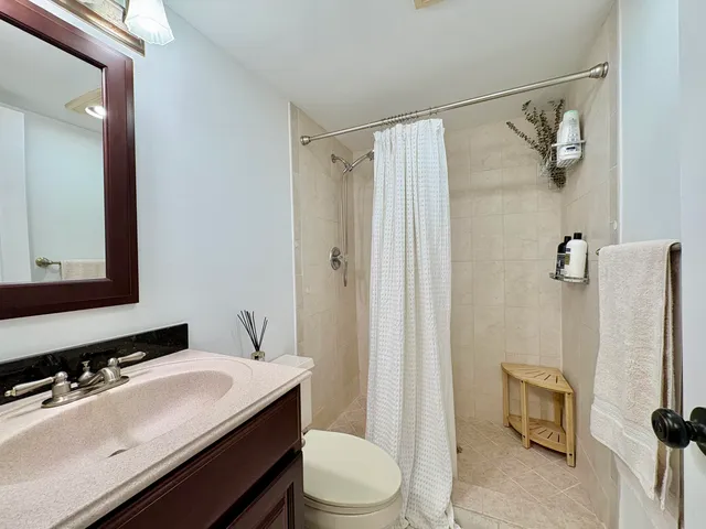 a bathroom with a sink toilet and shower