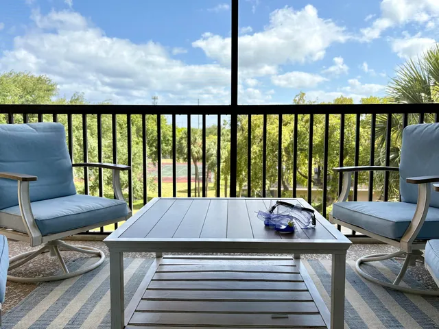 a view of a balcony with two chairs and a table