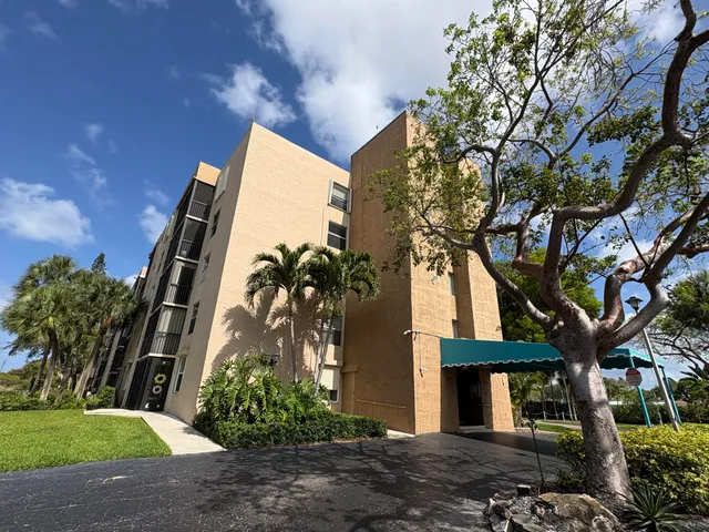 a view of a terrace with lawn chairs and iron fence
