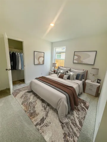 a bedroom with a bed and a painting on the wall