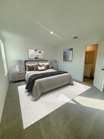 a bedroom with a bed and a couch