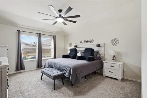 a bedroom with a large bed and a large window