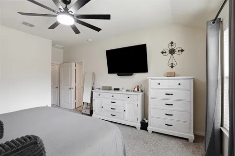 a bedroom with a bed and flat screen tv