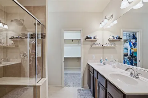a bathroom with a sink double vanity and shower
