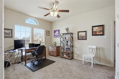 a view of a livingroom with workspace and a window
