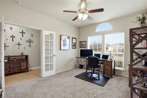 a view of a livingroom with workspace and a window