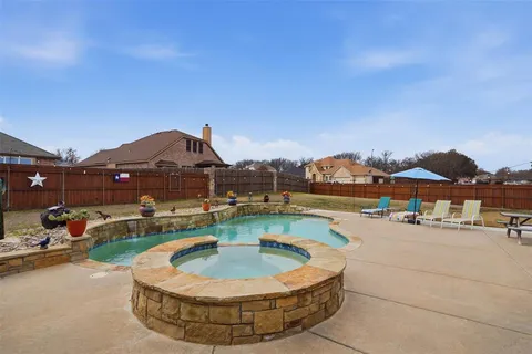 a view of a house with swimming pool and sitting area
