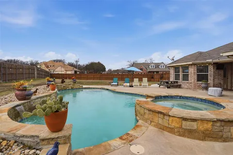 a view of a house with pool and chairs