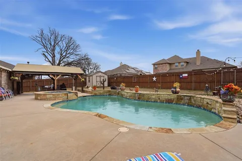 a view of house with garden space and car parked
