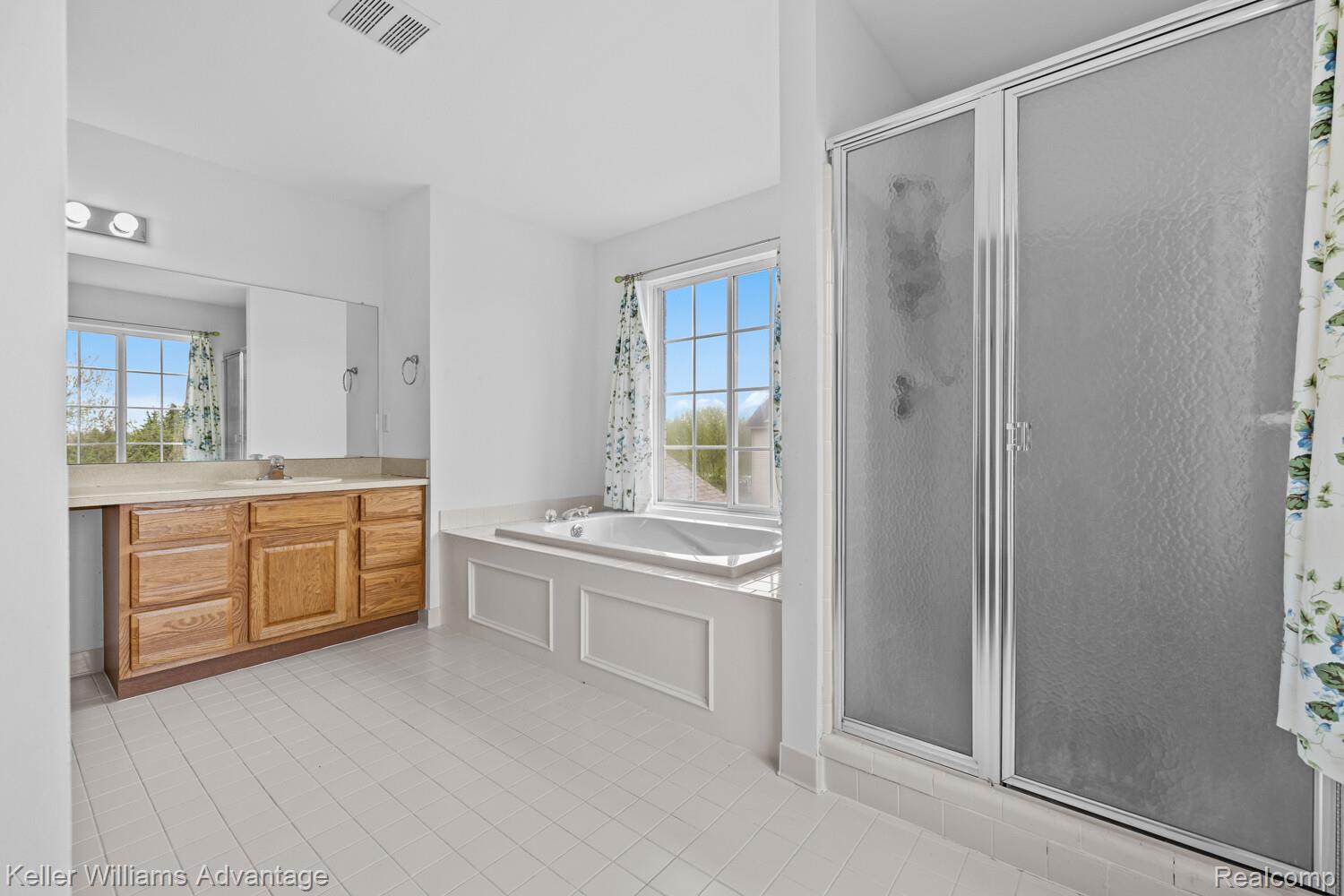 4100 Norwich Court Rochester, MI 48306 - Photo 38 of 72 Bathroom with a shower stall, a garden tub, vanity, and plenty of natural light