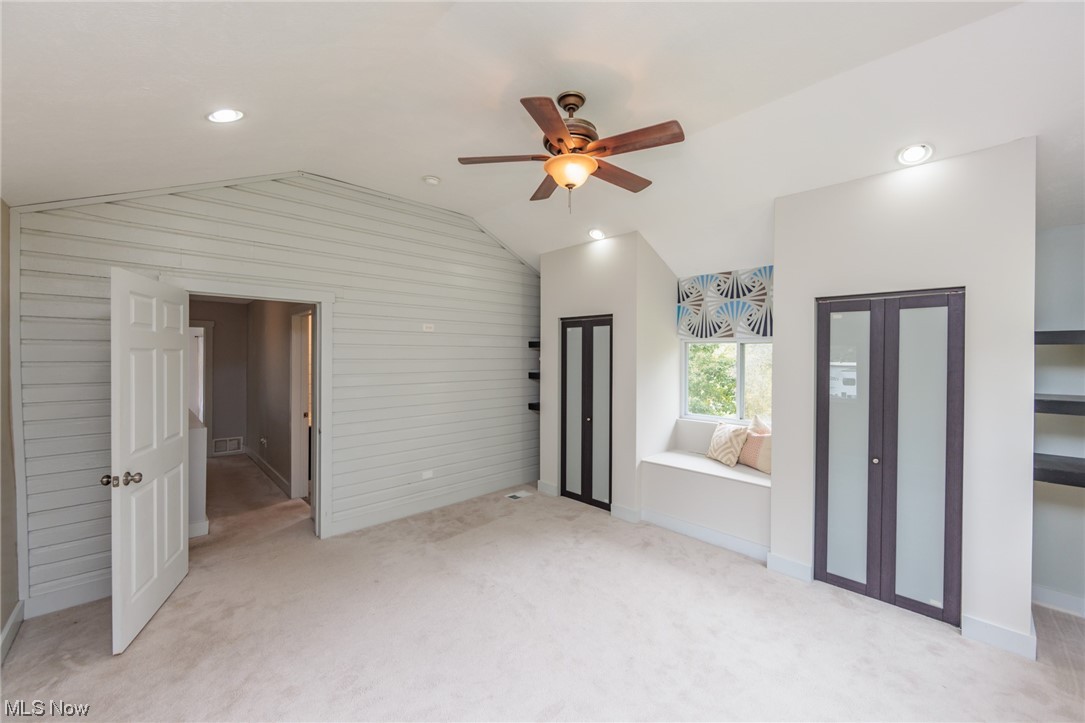 2551 Reimer Road Wadsworth, OH 44281 - Photo 26 of 35 Empty room with light colored carpet, vaulted ceiling, and ceiling fan