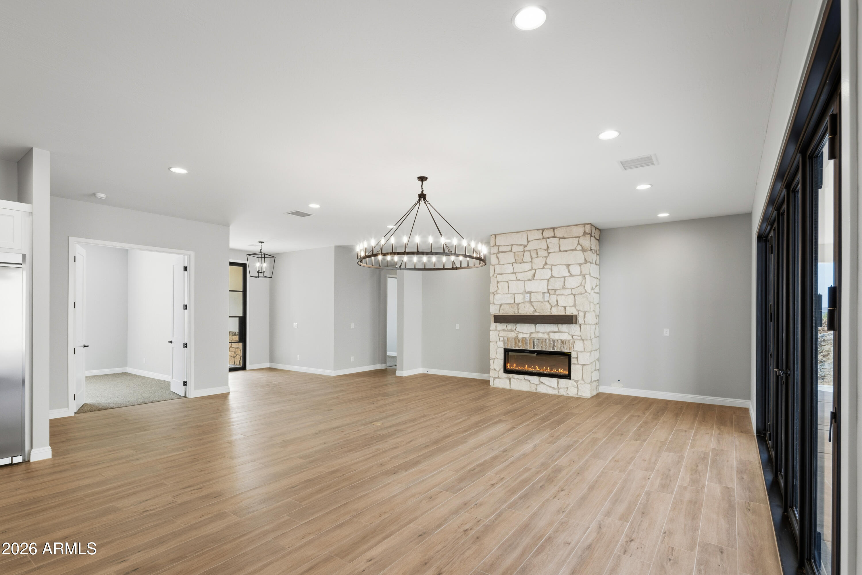 1687 East Creek Canyon Road Phoenix, AZ 85086 - Photo 6 of 31 an empty room with wooden floor fireplace and windows
