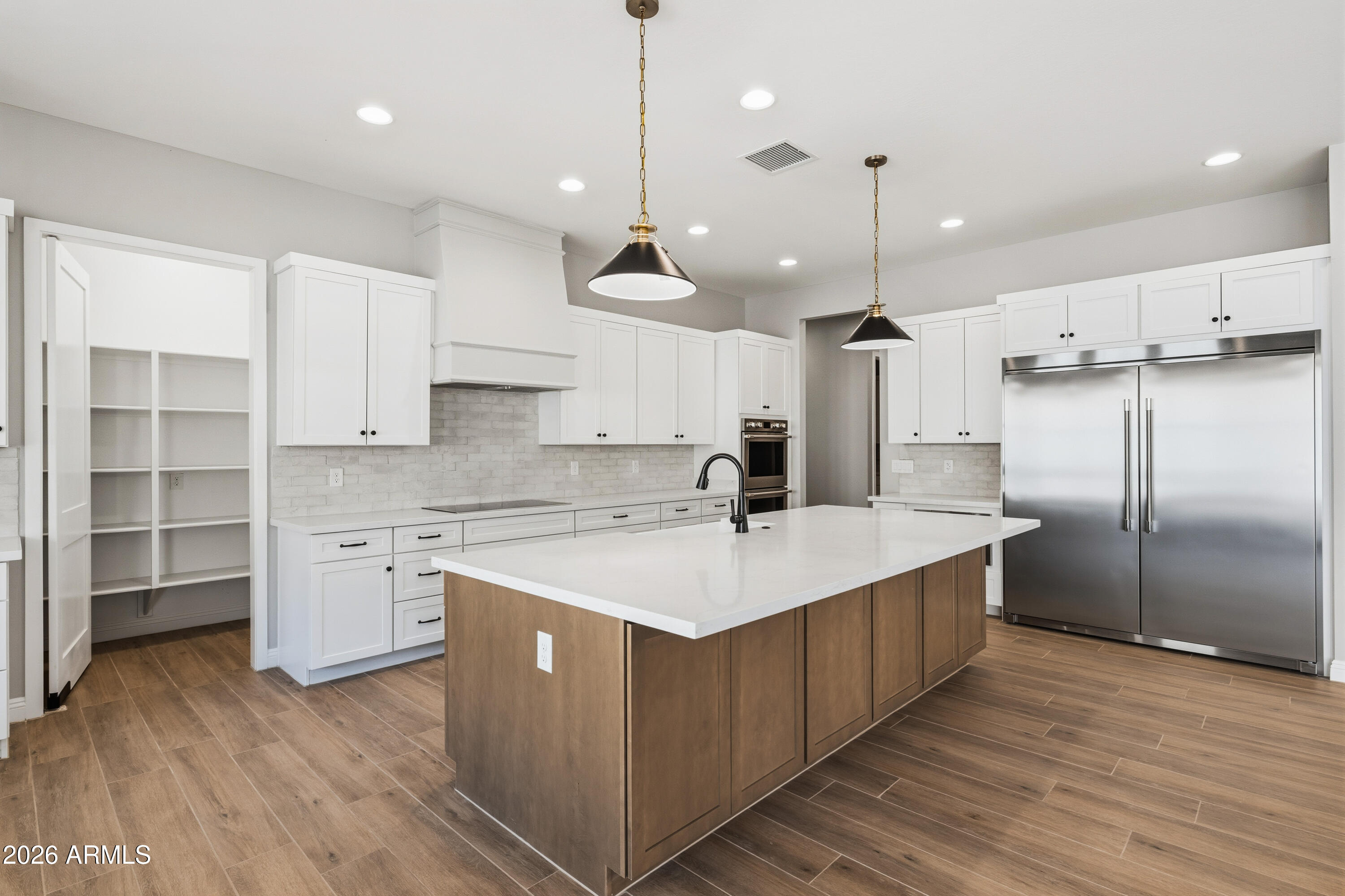 1687 East Creek Canyon Road Phoenix, AZ 85086 - Photo 8 of 31 a large kitchen with stainless steel appliances a large center island wooden floor and a sink