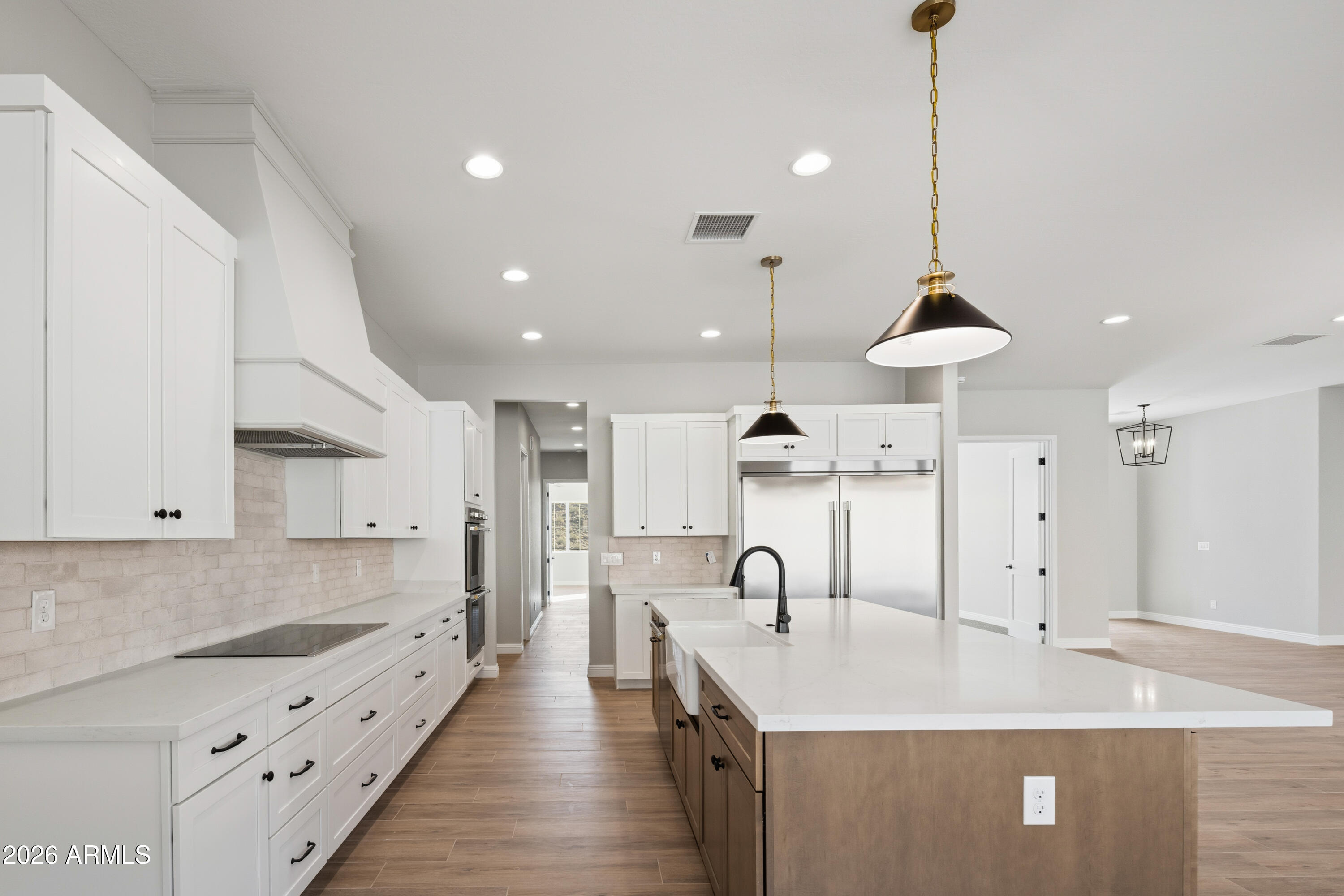 1687 East Creek Canyon Road Phoenix, AZ 85086 - Photo 9 of 31 a large kitchen with stainless steel appliances kitchen island a large island in the center
