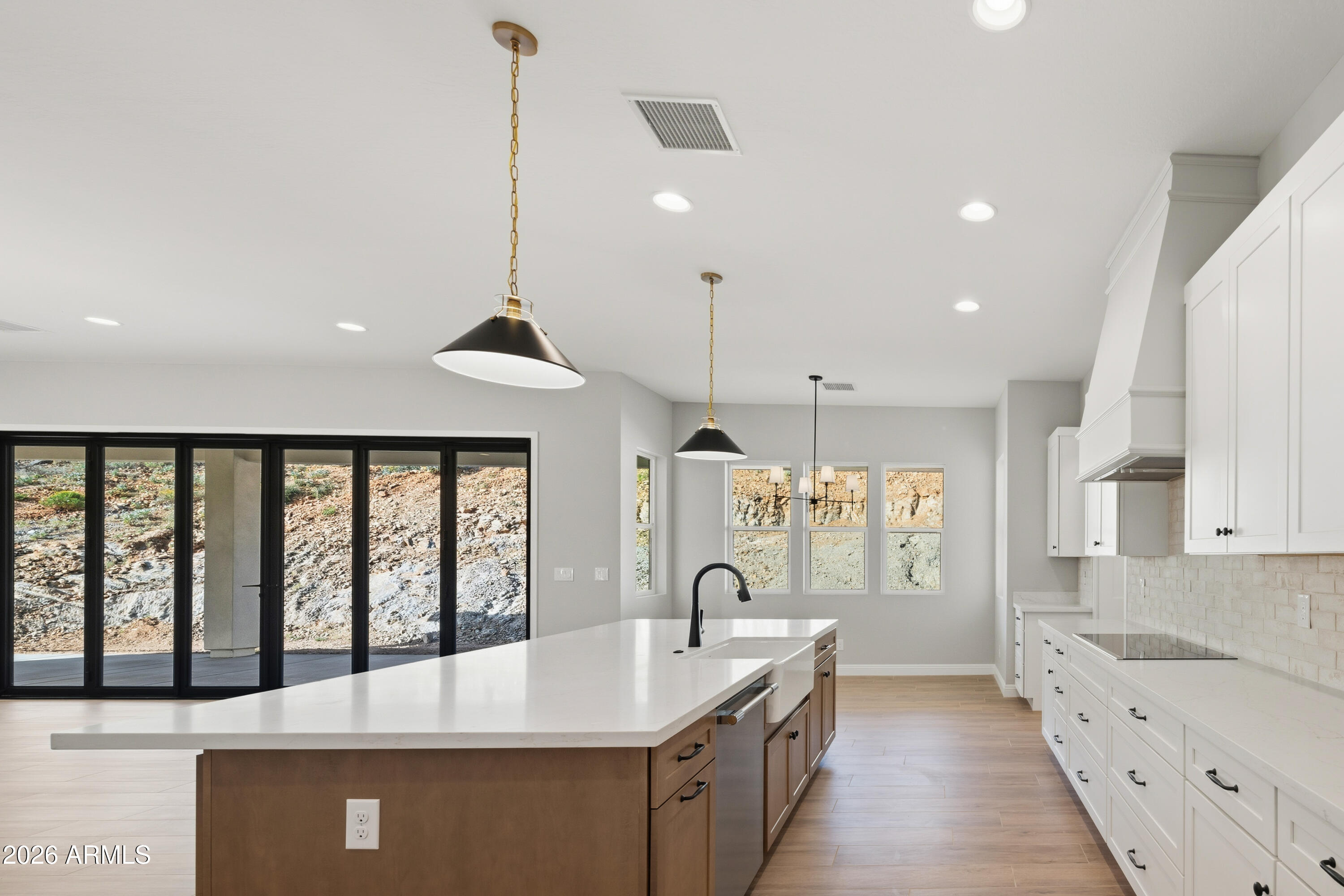 1687 East Creek Canyon Road Phoenix, AZ 85086 - Photo 10 of 31 a large kitchen with kitchen island a large island in it