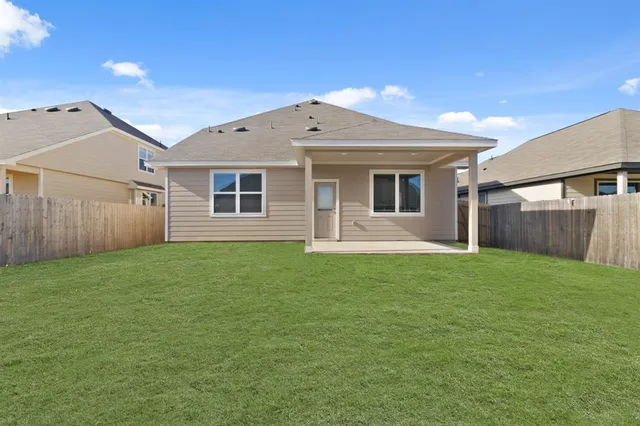 a view of a house with a backyard