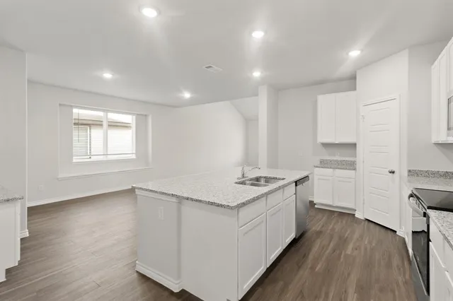 a kitchen with a stove a sink and a refrigerator