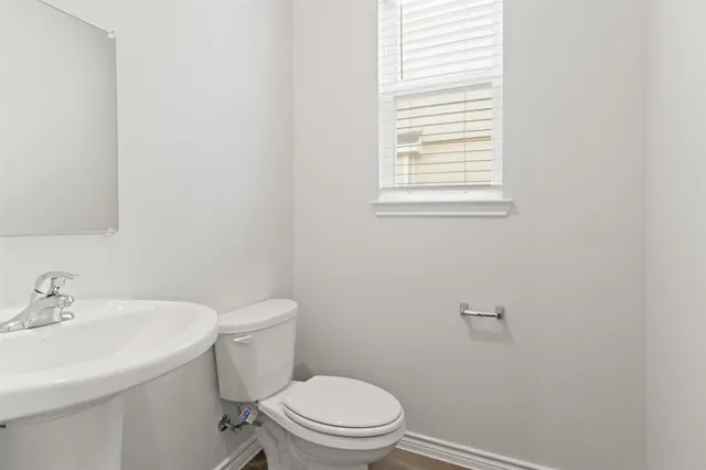 a white toilet sitting next to a white sink