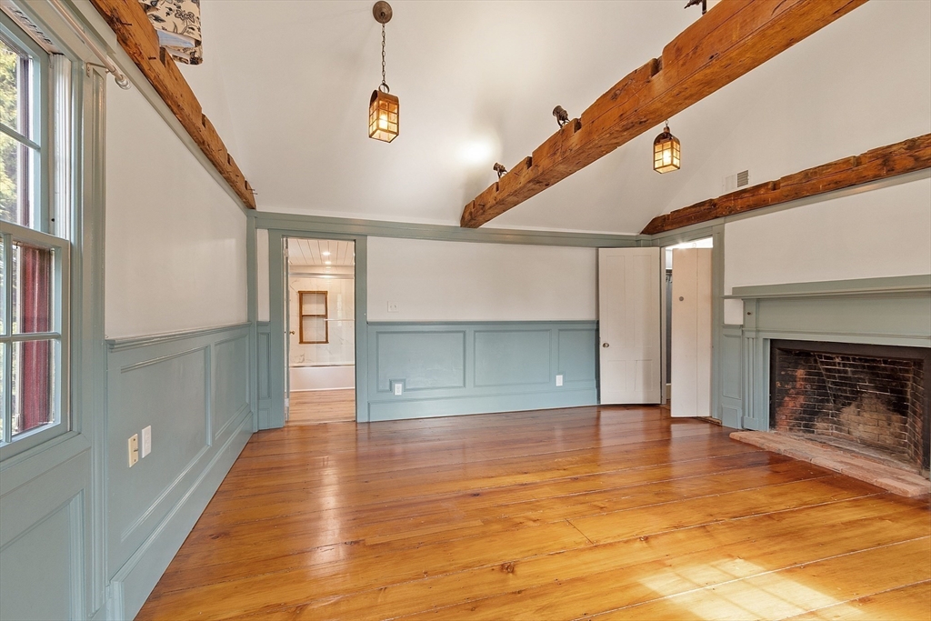156 Hale Street Beverly, MA 01915 - Photo 23 of 42 a view of a hallway with wooden floor and a fireplace