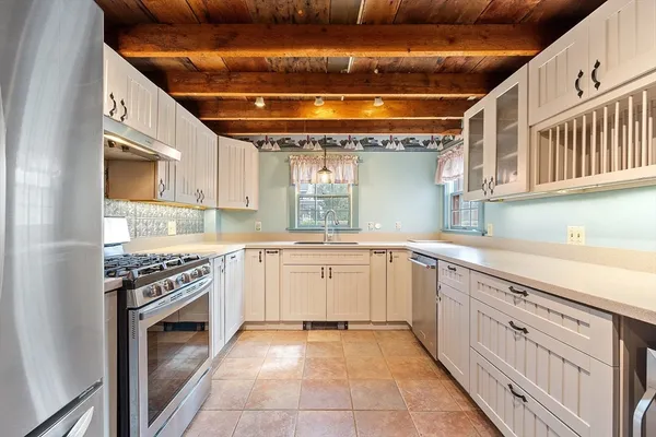 a kitchen with granite countertop a sink stove and cabinets