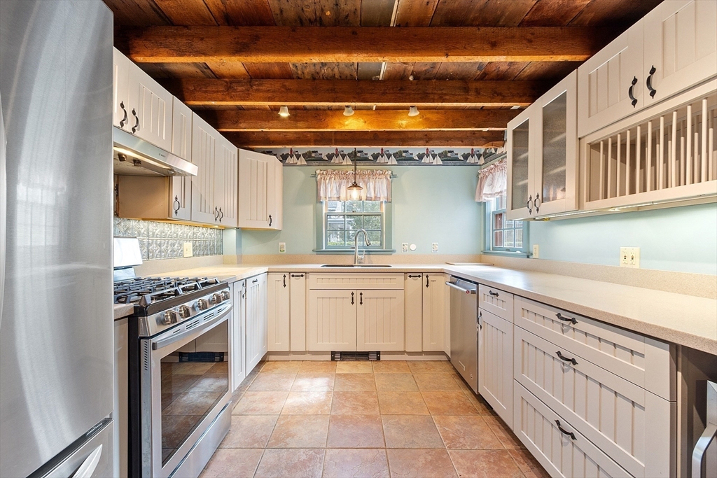 156 Hale Street Beverly, MA 01915 - Photo 4 of 42 a kitchen with granite countertop a sink stove and cabinets