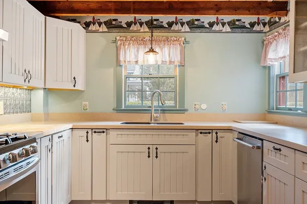 a view of a kitchen with a sink and cabinets