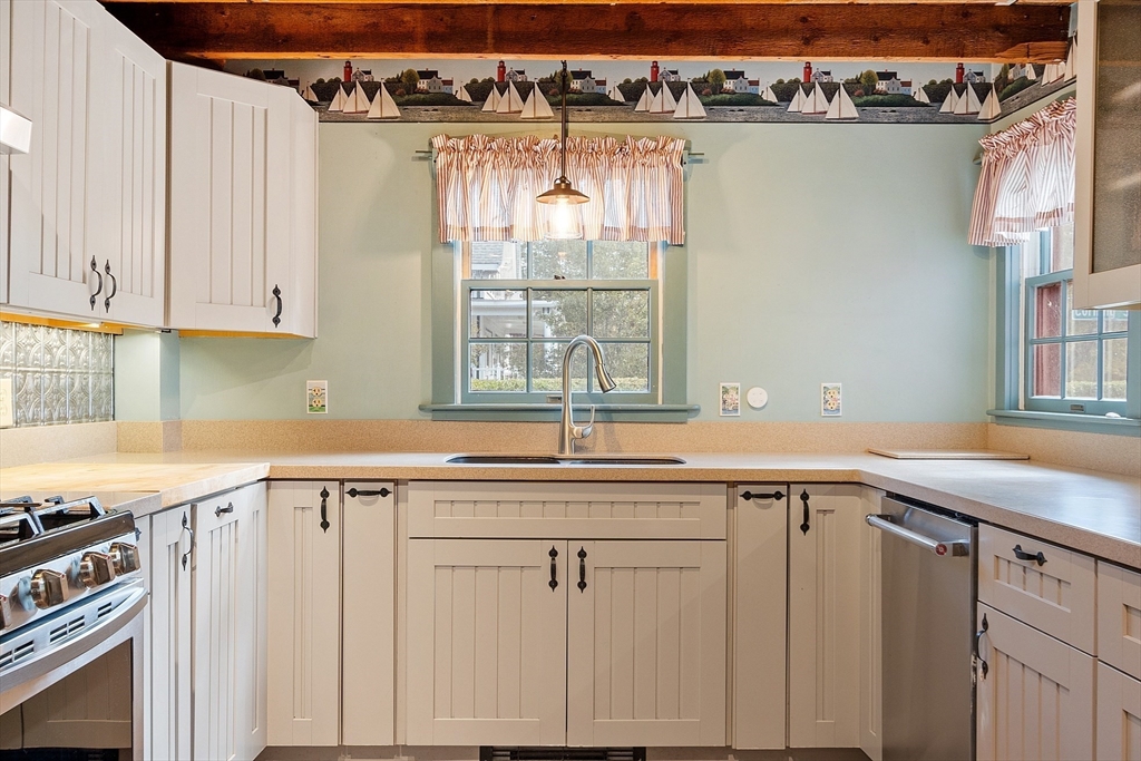 156 Hale Street Beverly, MA 01915 - Photo 5 of 42 a view of a kitchen with a sink and cabinets