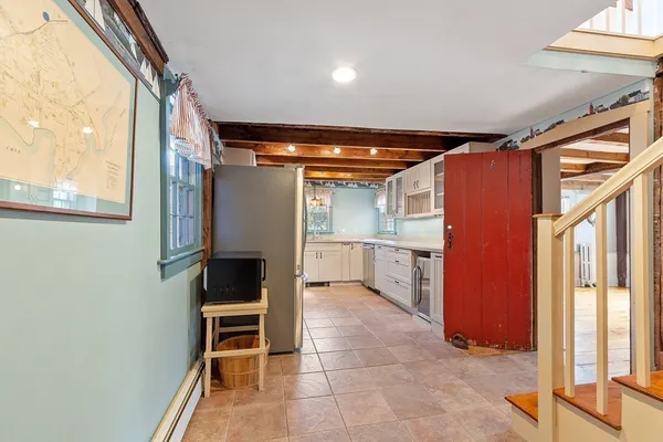a view of kitchen with microwave and refrigerator