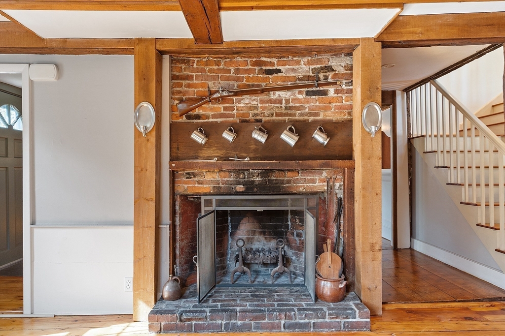 156 Hale Street Beverly, MA 01915 - Photo 9 of 42 a closeup of a fireplace with wooden floor