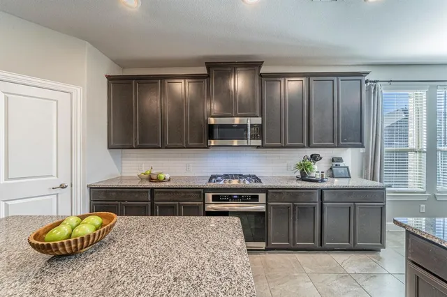 a kitchen with a sink cabinets and window