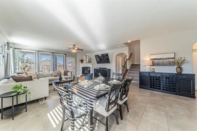 a dining room with furniture a rug and wooden floor